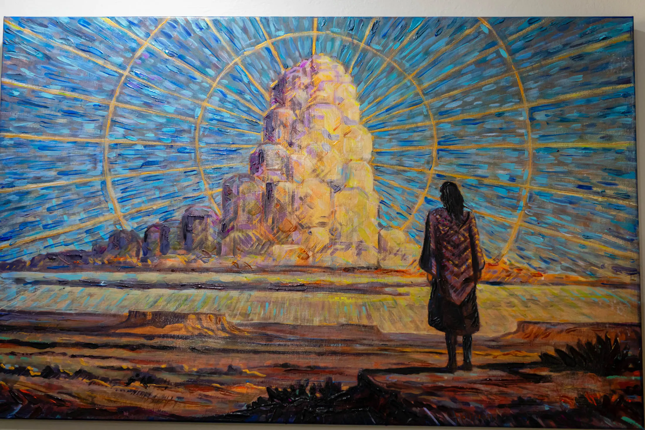 Figure gazing at radiant monolith in desert