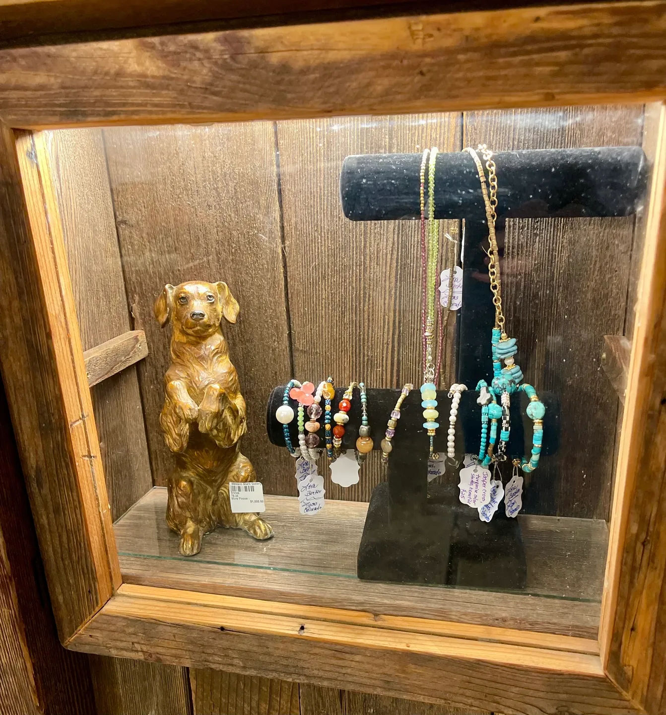 Elegant jewelry showcase with canine figure
