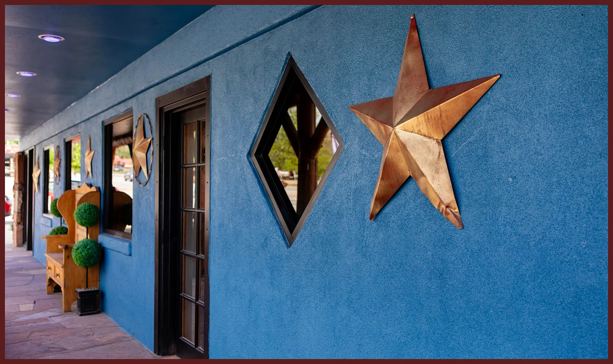 Blue stucco wall with large metal star